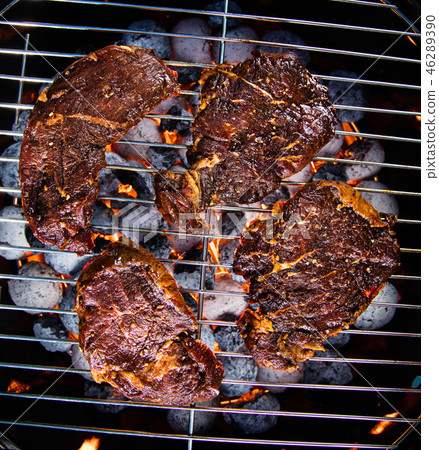 Barbecue grill with beef steaks, close-up. Barbecue grill with beef steaks, close-up. 46289390