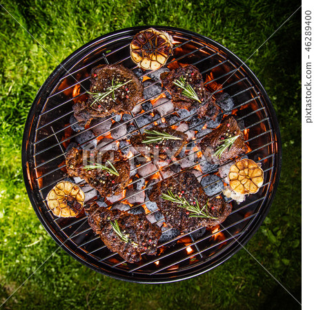 Barbecue grill with beef steaks, close-up. 46289400