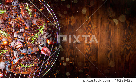 Barbecue grill with beef steaks, close-up. 46289423