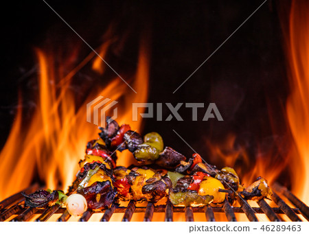 Tasty skewers on the grill with flames 46289463
