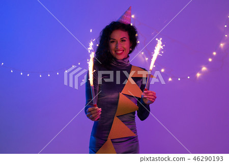 Young woman holding fireworks. Holiday, Event, celebration 46290193