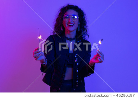 Young happy woman with sparklers. Celebrate Christmas and New Year Young happy woman with sparklers. Celebrate Christmas and New Year 46290197