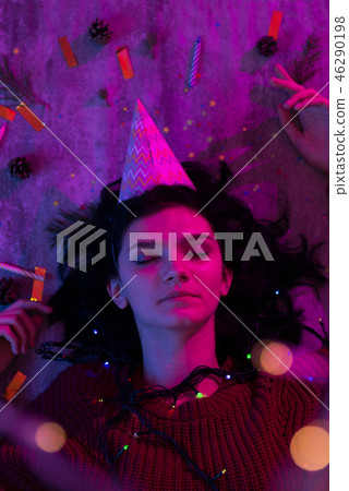 Young woman lying with xmas glowing lights Celebration, Christmas, New Year. Young woman lying with xmas glowing lights Celebration, Christmas, New Year. 46290198