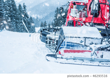 Red ratrac snowcat at work on on the ski slope 46293516