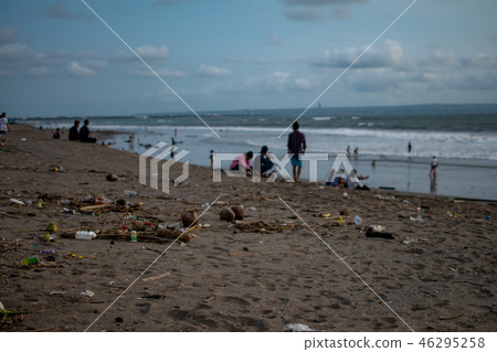 People seat near trash on the Beach, a lot of plastic garbide on the beach of Indian ocean People seat near trash on the Beach, a lot of plastic garbide on the beach of Indian ocean 46295258