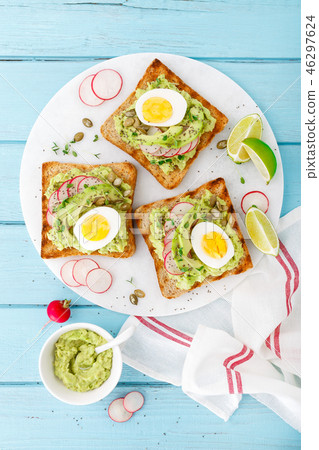Toasts with avocado guacamole, radish, boiled egg Toasts with avocado guacamole, radish, boiled egg 46297624