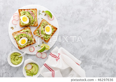 Toasts with avocado guacamole, radish, boiled egg Toasts with avocado guacamole, radish, boiled egg 46297636