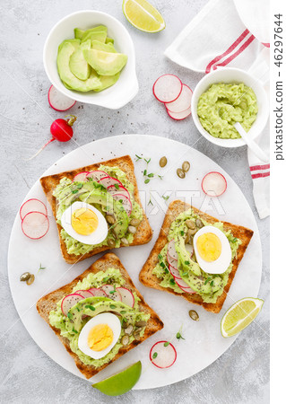 Toasts with avocado guacamole, radish, boiled egg 46297644