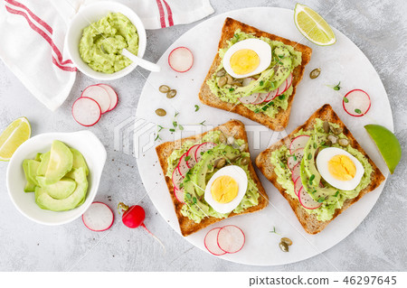 Toasts with avocado guacamole, radish, boiled egg Toasts with avocado guacamole, radish, boiled egg 46297645