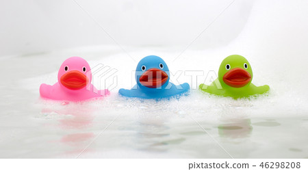 Pink, green and blue duck in a bathtub 46298208