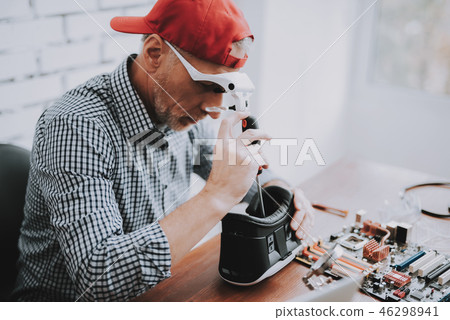 Bearded Old Man Repairing Motherboard from PC. Bearded Old Man Repairing Motherboard from PC. 46298941