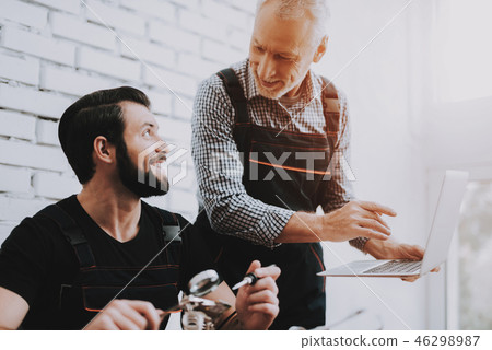 Two Men Repairing Hardware Equipment in Workshop. 46298987