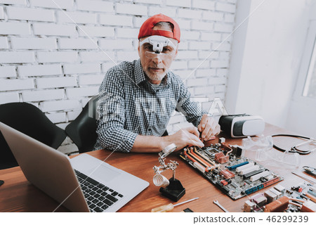 Bearded Old Man Repairing Motherboard from PC. 46299239