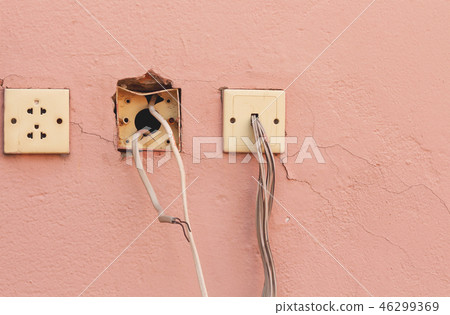 Old electricity socket and wires on cement wall. 46299369