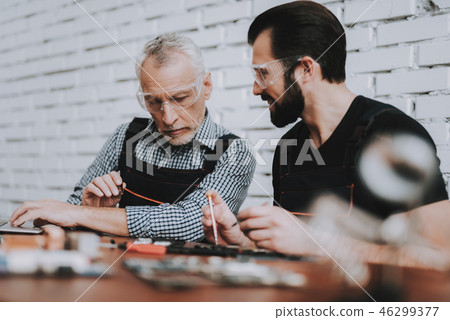 Two Men Repairing Hardware Equipment from PC. Two Men Repairing Hardware Equipment from PC. 46299377