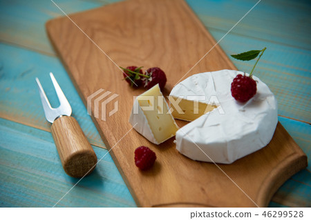 cheese camembert or brie on blue wooden background cheese camembert or brie on blue wooden background 46299528