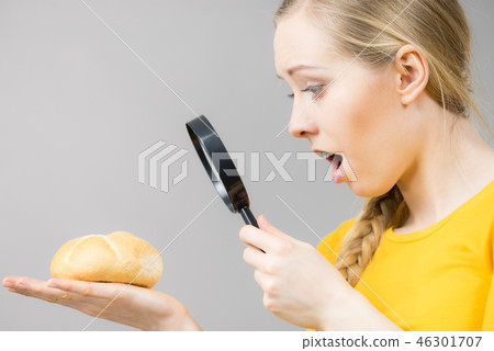 Shocked woman magnifying bun bread roll Shocked woman magnifying bun bread roll 46301707
