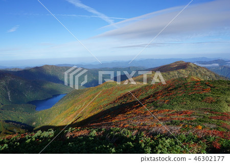 The autumn leaves and the Otoriike from the Aso mountain range Higashidake Obsoube mountain trail 46302177