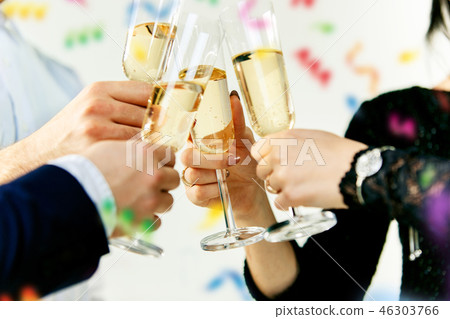 Celebration. Hands holding the glasses of champagne and wine making a toast. 46303766
