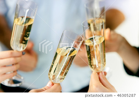 Celebration. Hands holding the glasses of champagne and wine making a toast. 46305287