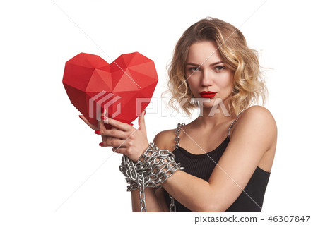 Woman holding red polygonal paper heart shape with tied by chain hands Woman holding red polygonal paper heart shape with tied by chain hands 46307847