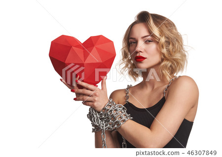 Woman holding red polygonal paper heart shape with tied by chain hands Woman holding red polygonal paper heart shape with tied by chain hands 46307849