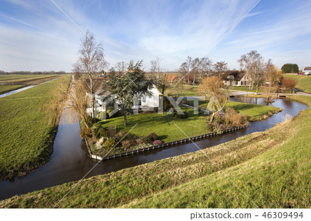 Dutch polder landscape with a farm and some houses Dutch polder landscape with a farm and some houses 46309494
