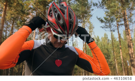 Training an athlete on the roller skaters. Biathlon ride on the roller skis with ski poles, in the Training an athlete on the roller skaters. Biathlon ride on the roller skis with ski poles, in the 46310658
