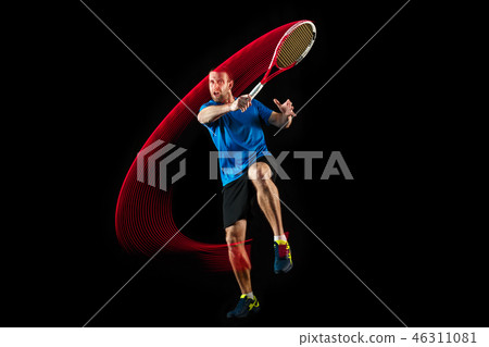 one caucasian man playing tennis player on black background one caucasian man playing tennis player on black background 46311081