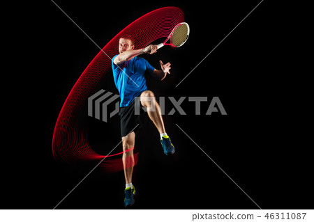 one caucasian man playing tennis player on black background one caucasian man playing tennis player on black background 46311087