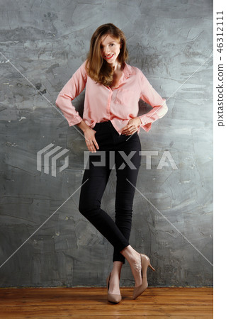 Sly, tricky girl standing near the wall  46312111