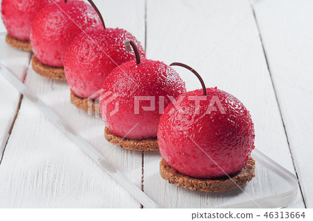 round cakes on white wooden table. cherry shape 46313664