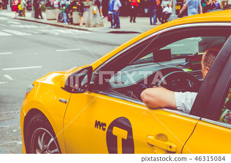 Yellow cab speeds through Times Square the busy 46315084