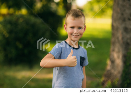 Cheerful boy spent time in park. Ten year old child smile and have fun 46315125