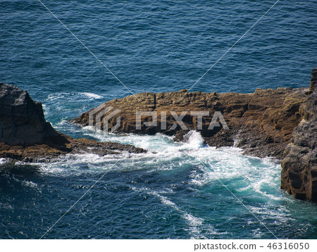 The sea breaks at the brown rock in the Atlantic The sea breaks at the brown rock in the Atlantic 46316050