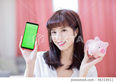 Happy woman with piggy bank 46319911