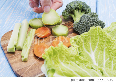 A set of fresh vegetables on a wooden table. 46320959