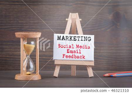 Marketing Strategy concept. Sandglass, hourglass or egg timer on wooden table Marketing Strategy concept. Sandglass, hourglass or egg timer on wooden table 46321310