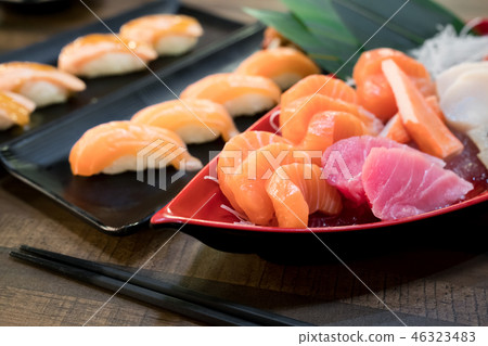Mixed sliced fish sashimi on ice in white bowl. Mixed sliced fish sashimi on ice in white bowl. 46323483