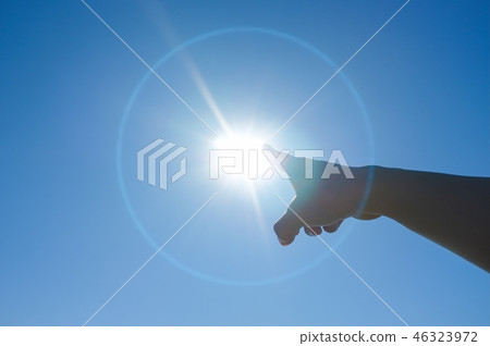 Young woman hand pointing to the sun Young woman hand pointing to the sun 46323972
