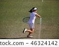 Junior tennis player hitting forehand stroke on a natural turf court 46324142