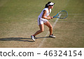 Junior tennis player with receive on a natural turf court 46324154