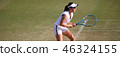 Junior tennis player with receive on a natural turf court 46324155