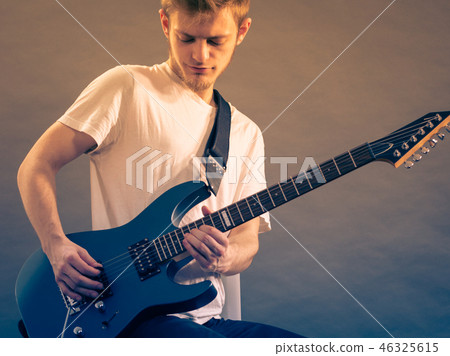 Young man playing electric guitar 46325615