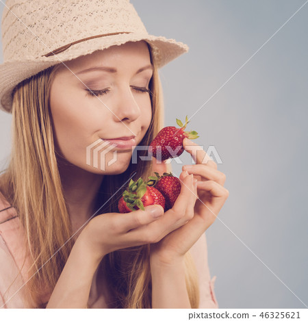 Young woman with fresh strawberry Young woman with fresh strawberry 46325621