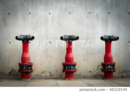 Three fire safety pump on cement floor of building 46328549