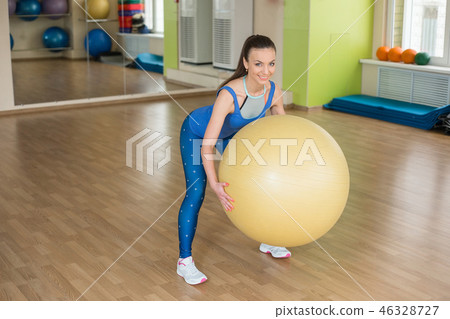 Young fitness woman doing slopes with fitball Young fitness woman doing slopes with fitball 46328727