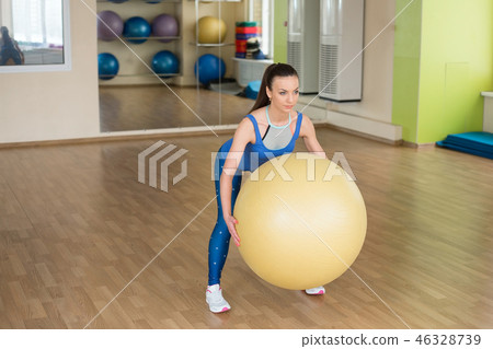 Young fitness woman doing slopes with fitball 46328739