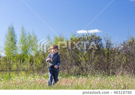 child jumping in a summer park. 46328780