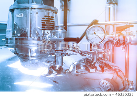 pressure meter on big steel tank. Blue tone. Blue tint pressure meter on big steel tank. Blue tone. Blue tint 46330325